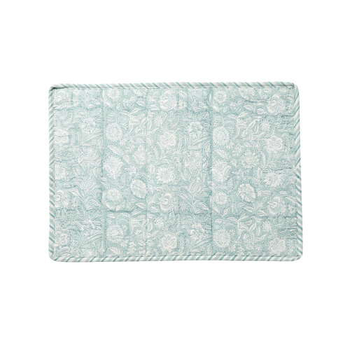 Floral patterned placemat on white background.