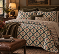 a bed with pillows and a blanket in a room