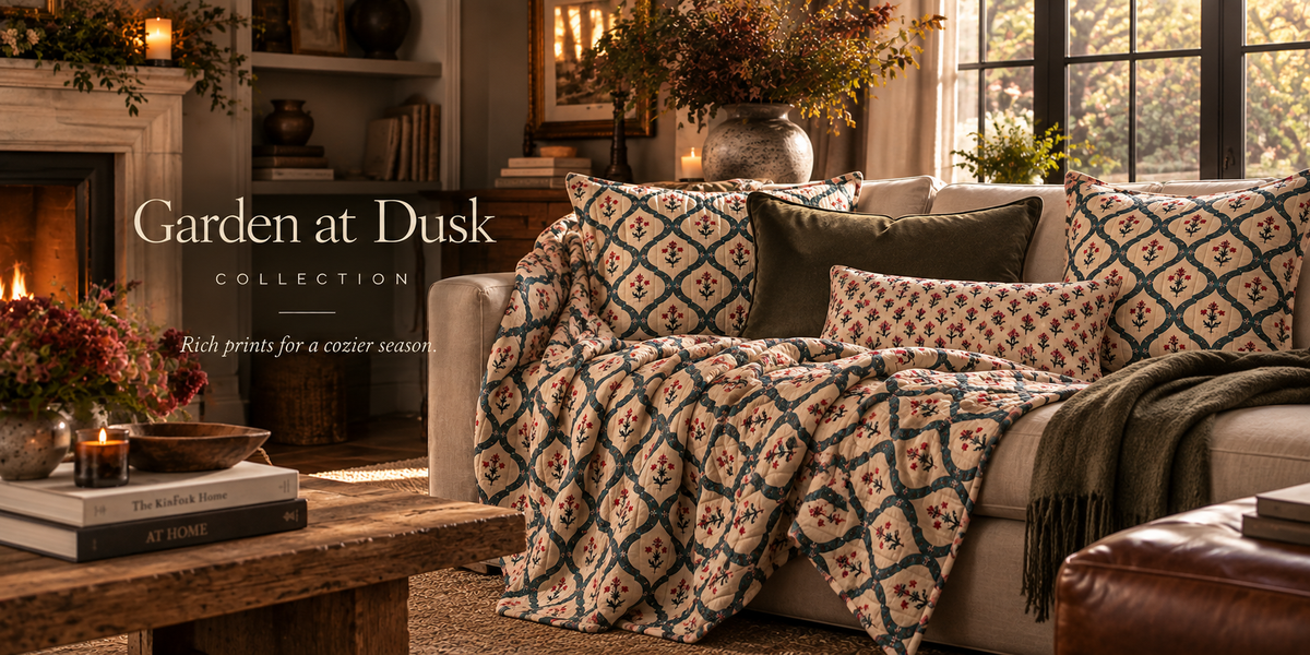 a couch with pillows and a blanket in a living room