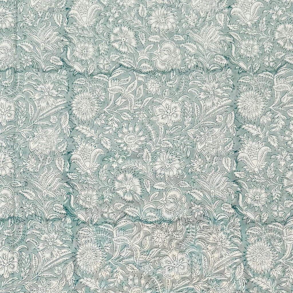 White and blue floral patterned table cloth. 