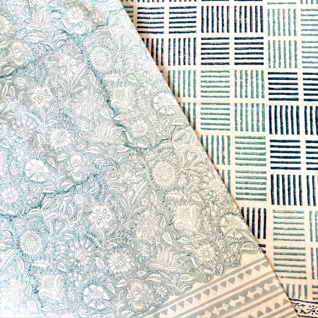 Two different patterned table cloths with floral and geometric patterns.