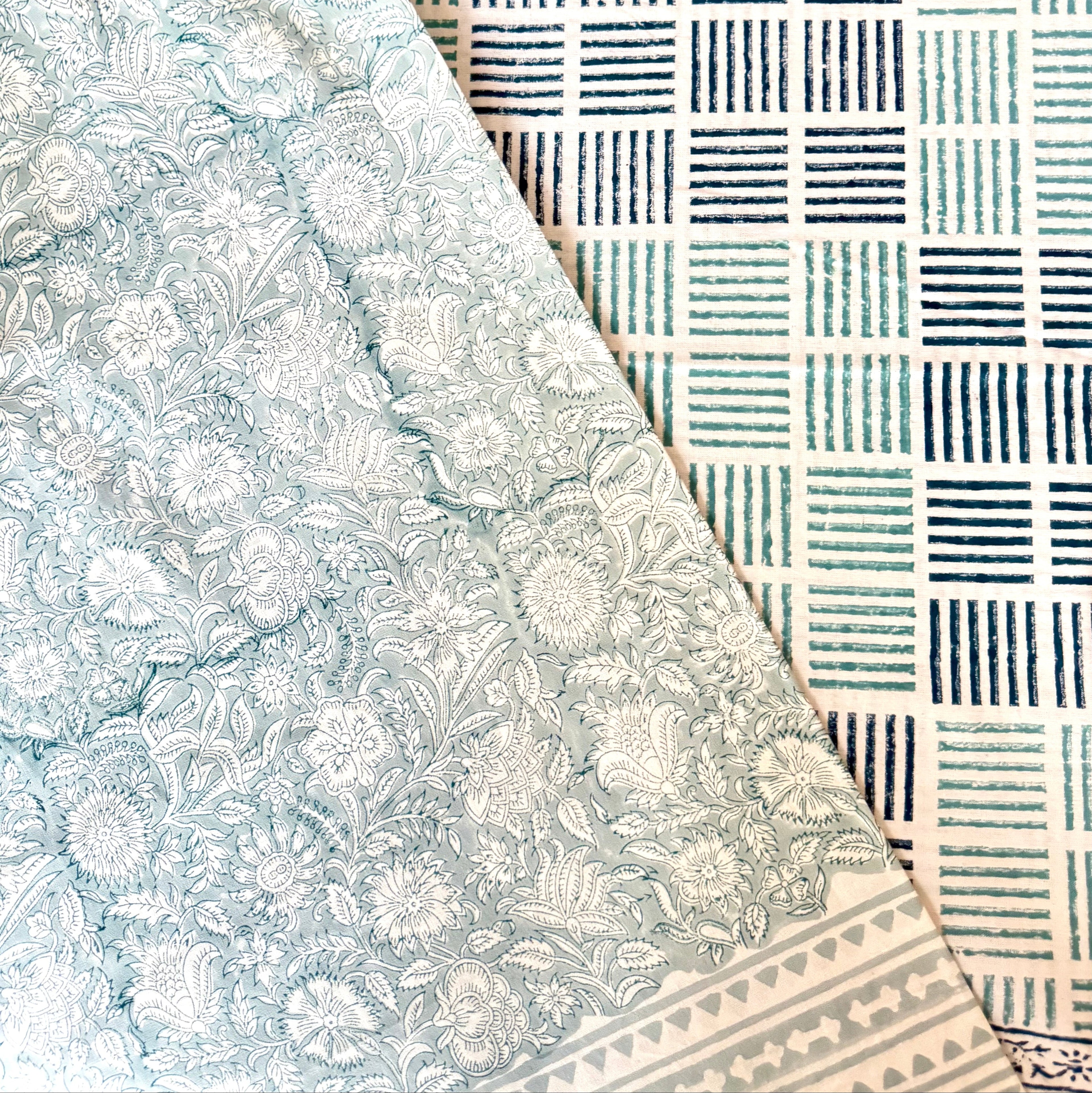 Two different patterned table cloths with floral and geometric patterns.