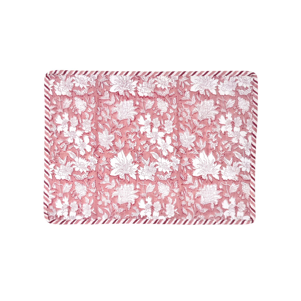 Floral patterned placemat with pink and white design on a white background