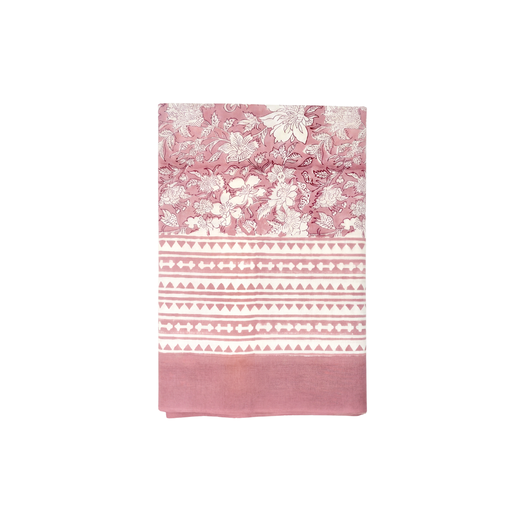 Pink tablecloth with floral and geometric patterns on a white background