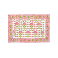 Floral patterned tablecloth with pink flowers and green leaves on a white background